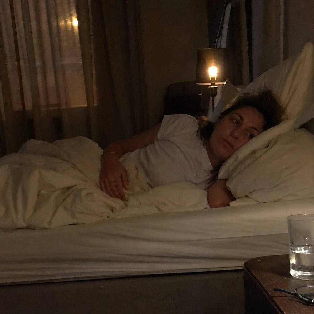 Woman lying awake and uncomfortable during the night